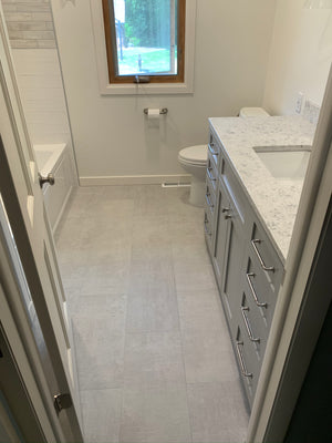 Tub Shower Combo W/ Accent Lighting On Wood Appearance Tile