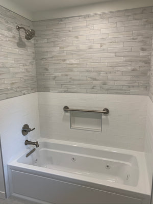 Tub Shower Combo W/ Accent Lighting On Wood Appearance Tile